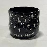 The Black Starry Planter is a ceramic cup in black, featuring white stars and the phrase 