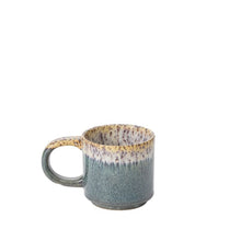 Load image into Gallery viewer, Part of the Starling Mug Collection, this ceramic stoneware mug features a wide handle and a reactive glaze with a textured greenish-blue gradient base, transitioning to cream with speckles near the rim. The background is plain white.