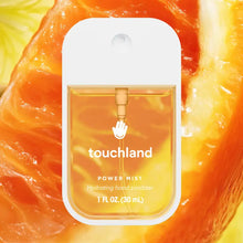 Load image into Gallery viewer, A bottle of Touchland Hand Sanitizer Mist with orange liquid is shown against a close-up juicy orange slice background, keeping your hands clean and hydrated.