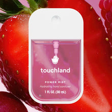 Load image into Gallery viewer, A pink bottle of Touchland Hand Sanitizer Mist is centered before a close-up of fresh strawberries. Its delicately scented formula hydrates hands, and the sleek container holds 1 fl oz (30 mL).