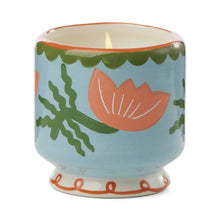 Load image into Gallery viewer, The A Dopo 8oz Ceramic Candle features a hand-painted design on a ceramic holder with a light blue background, pink flowers with green stems and leaves, a green scalloped rim, and a wavy red pattern at the base.