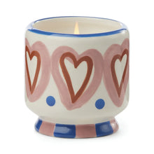 Load image into Gallery viewer, The A Dopo 8oz Ceramic Candle comes in a decorative ceramic holder with pink hearts, red outlines, blue dots, a blue and pink striped base, and is infused with a soothing Mediterranean fragrance.