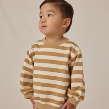 Load image into Gallery viewer, A young child with short dark hair looks upward while wearing the Oversized Crew Sweatshirt, made from organic cotton, standing against a plain light background.
