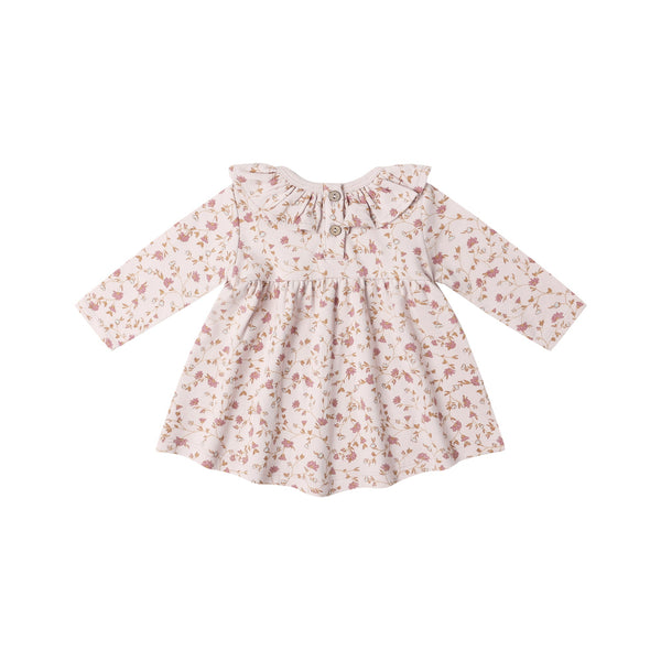The Ruffle Collar Jersey Dress is a long-sleeved organic cotton baby dress with pink and brown floral garden print on white, featuring a ruffled collar, front buttons, and gathered waist for cute style and comfort.