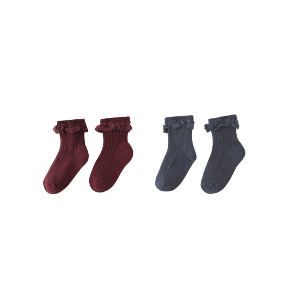 This 2-Pack Socks set for children includes two styles: one pair in dark red and one in dark gray, both with a delicate frilly lace trim at the top.