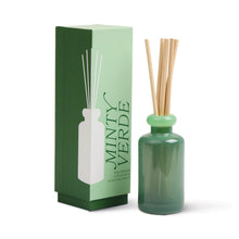 Load image into Gallery viewer, A green Stacked Reed Diffuser bottle with wooden reeds stands next to a matching Minty Verde box—ideal for infusing your home with refreshing fragrance.