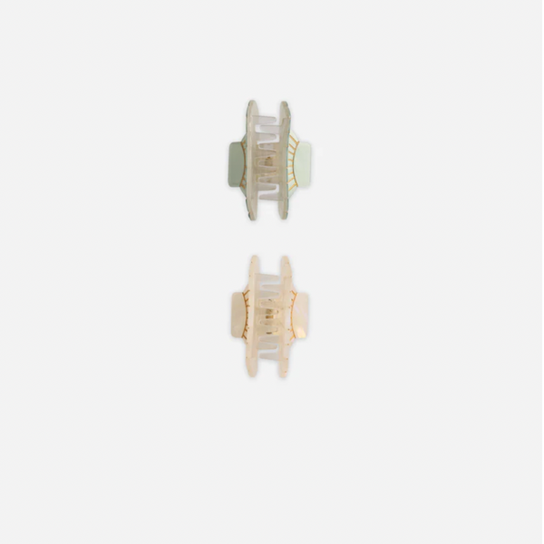 The Shell Clip Set - Seafoam/Natural features two small, translucent rectangular hair claws in soft sage green and light beige, displayed vertically on a white background for an easy coastal summer vibe.