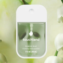 Load image into Gallery viewer, A rectangular Touchland Hand Sanitizer Mist bottle with clear green liquid and a white cap is displayed on a soft green background with white flowers, offering hydrated, fresh, and delicately scented hands.
