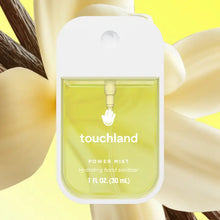 Load image into Gallery viewer, A bottle of Touchland Hand Sanitizer Mist with yellow liquid sits centered before a blurred vanilla flower. The label shows the product name and 1 FL OZ (30 mL), offering delicately scented, hydrated hands.