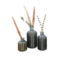 Load image into Gallery viewer, A Blue Stoneware Vase with intricate gold and striped patterns holds dried pampas grass and eucalyptus, arranged on a white background.