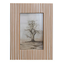 Load image into Gallery viewer, The 4x6 Resin Striped Frame features vertical tan and white stripes and displays a black and white drawing of a solitary leafless tree on a barren landscape.