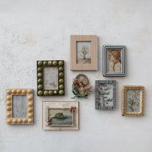 Load image into Gallery viewer, Seven framed artworks are arranged on a textured white wall, featuring paintings, botanical prints, and an illustrated open book in decorative frames such as an elegant frame and a 4x6 Resin Striped Frame.