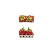Load image into Gallery viewer, Two strawberry-shaped stoneware salt and pepper shakers with green tops are displayed in a small rectangular white berry basket holder. The Strawberry S+P Shakers are shown from both top and front angles.