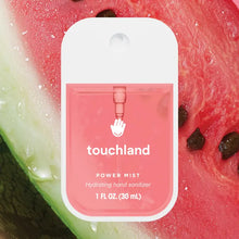 Load image into Gallery viewer, A pink bottle of Touchland Hand Sanitizer Mist is shown in front of sliced watermelon, with a clear label emphasizing its hydrating skincare formula and delicate scent.