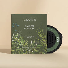 Load image into Gallery viewer, A round black Pura Car Diffuser Refill sits stylishly beside a green botanically illustrated box labeled “ILLUME Balsam &amp; Cedar Car Diffuser Refill,” both displayed on a neutral beige background.