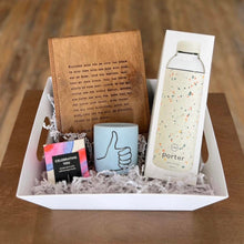 Load image into Gallery viewer, Create the perfect gift with Lit Decor and Gifts Custom Gift Boxes featuring a white tray, brown notebook, light blue thumbs-up mug, speckled Porter water bottle, and a vibrant CELEBRATING YOU box on white decorative paper.