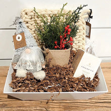 Load image into Gallery viewer, The Custom Gift Box by Lit Decor and Gift includes a knitted cream blanket, small plush gnome, faux plant with red berries, and Frasier Fir candle—artfully arranged on shredded brown paper in a white tray.
