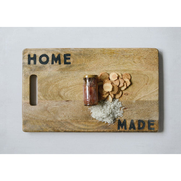 The Lit Decor and Gift Home Made Cutting Board, crafted from mango wood with HOME and MADE on opposite corners, is perfect for serving snacks or as a thoughtful housewarming gift.
