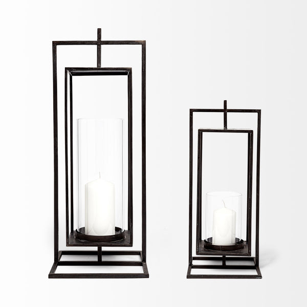 Lit Decor and Gifts Black Metal Candle Holder - 2 Sizes features two elegant black lanterns, each holding a white pillar candle in a cylindrical glass holder, showcased against a plain white background.