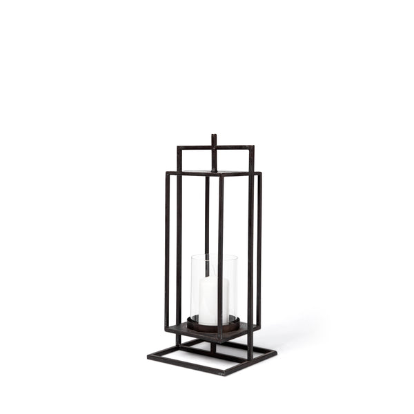 The Lit Decor and Gift Black Metal Candle Holder, available in 2 sizes, features a geometric rectangular black metal frame with a glass cylinder for a white pillar candle, displayed against a plain white background.
